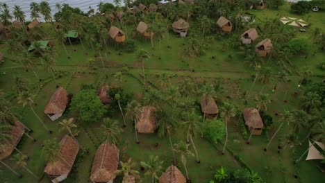 several rural huts in beachfront resort of tropical island