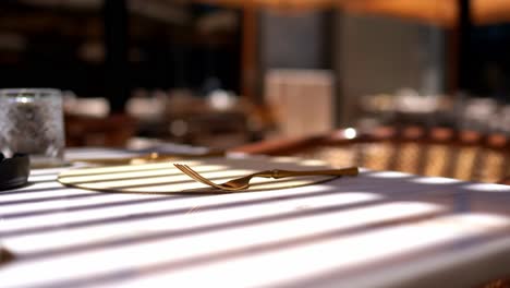 Front-view-of-stylish-and-light-dining-table-in-restaurant-close-up-shot