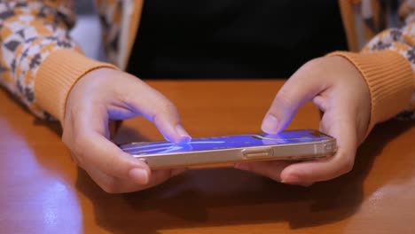 Detail-of-female-hands-playing-with-cell-phone