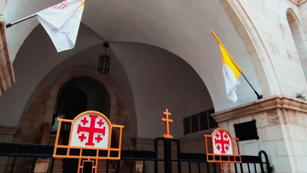 Flags and Crosses at the Entrance of a Church in Jerusalem