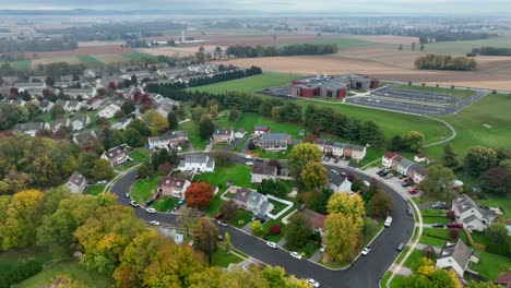 Colorful-neighborhood-in-autumn-with-new-elementary-school-in-background