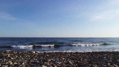 slowly moving forward and panning right on a rocky beach