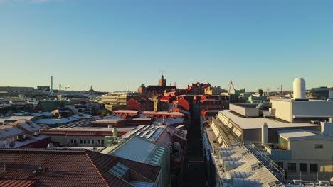 flying over the street and buildings at gothenburg, sweden during sunset