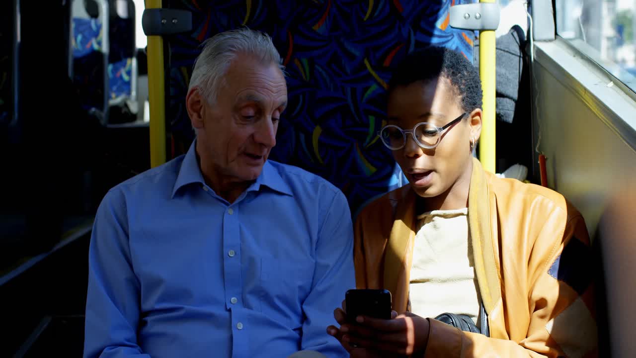 Commuters interacting with each other while using mobile phone 4k