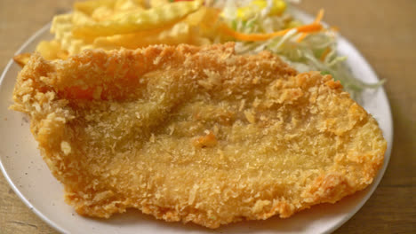 fried fish fillet and potatoes chips with mini salad