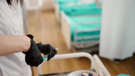 Nurse-taking-medicine-with-syringe-from-ampule-at-hospital