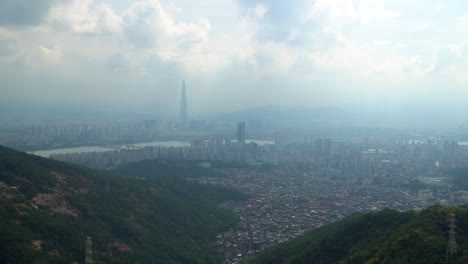 seoul city skyline on hazy day with high levels of micro dust air pollution from acha mountain peak  - lotte tower and han river in background, climate change
