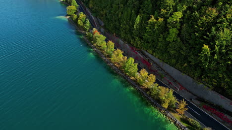 Aerial-drone-view-of-a-remote-lakeshore-drive-in-around-Lake-Attersee