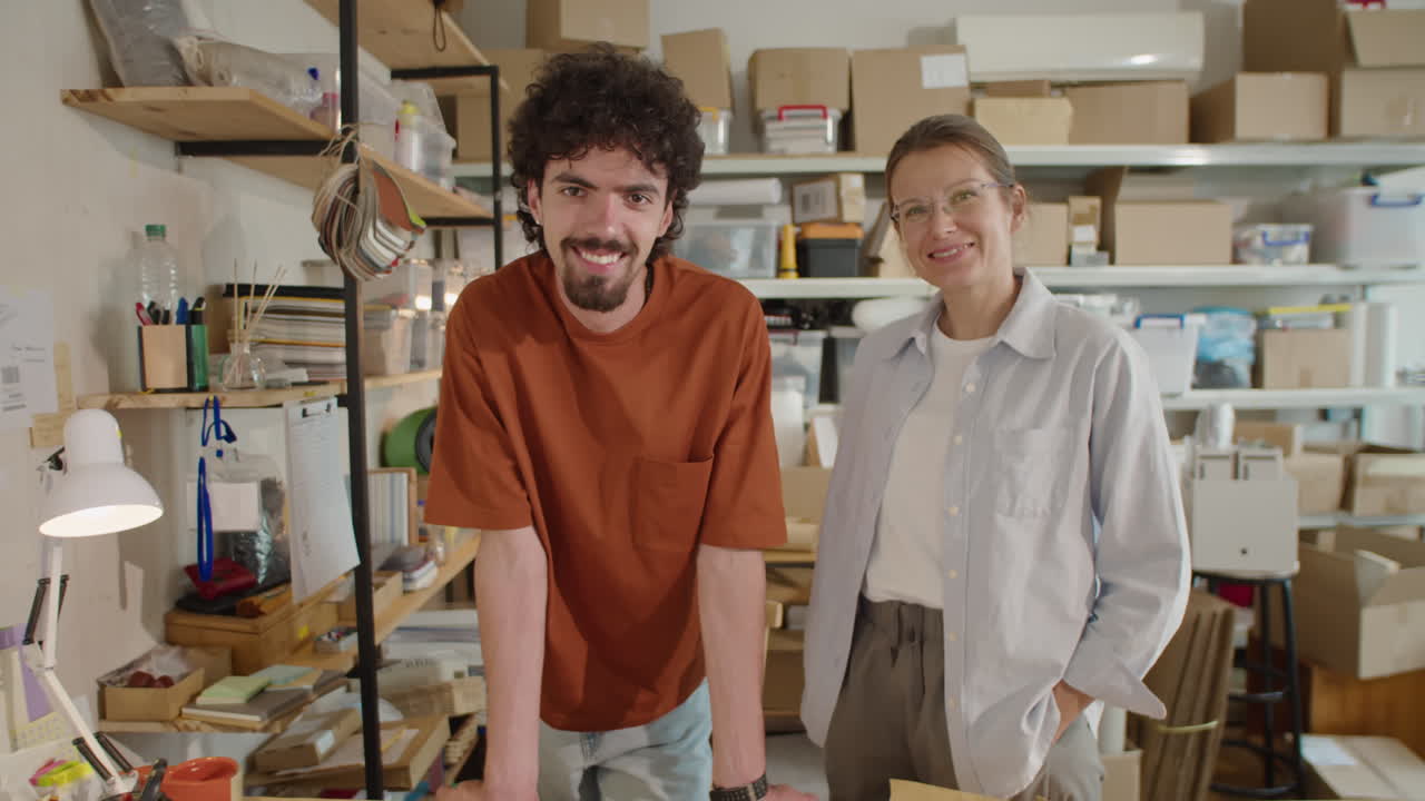 Two Colleagues Posing on Camera in Online Store Warehouse
