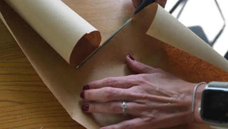 woman cutting wrapping paper