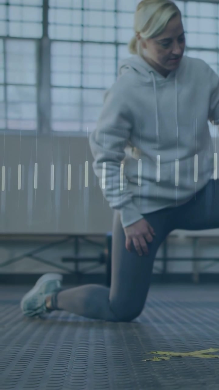 Female exerciser kneeling in gym shifting weight and causing HUD line graph tracking form