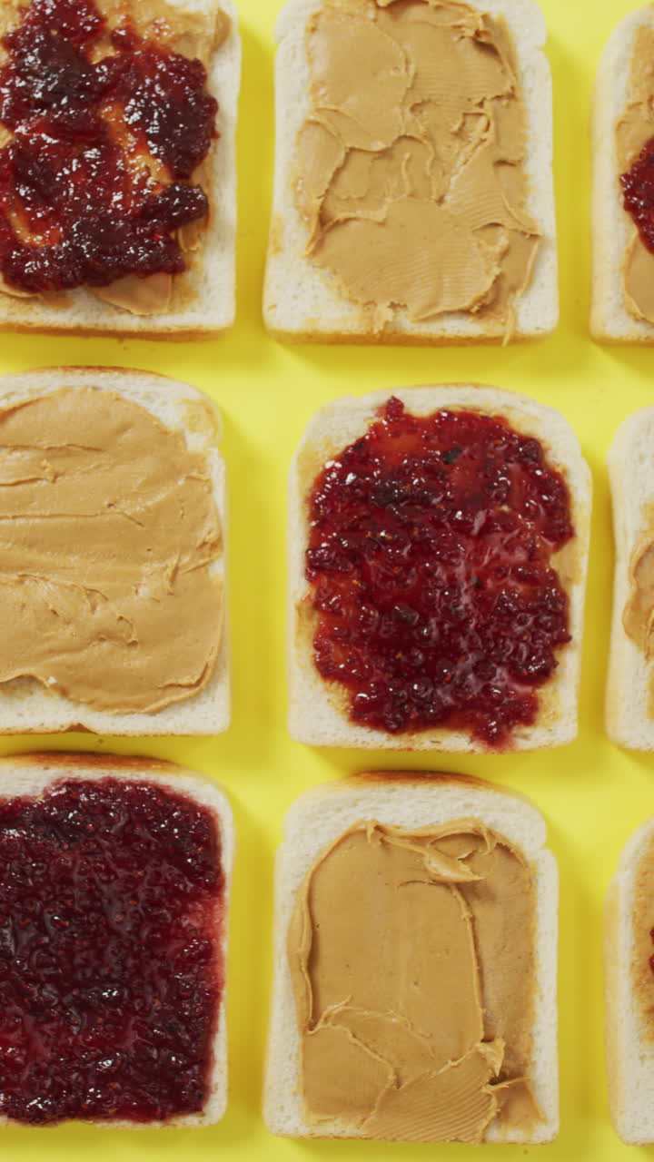 Vertical video of sandwiches with jam and peanut butter