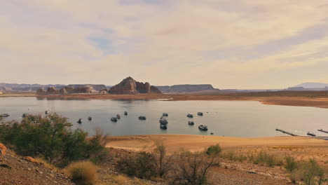 Scenic-view-of-boats-on-calm-Lake-Powell-with-warm-morning-light