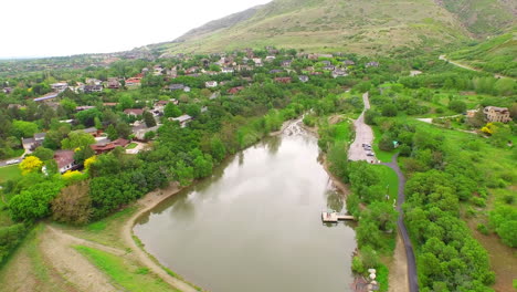 an areal view of a body of water or pond in the middle of a suburban neighborhood