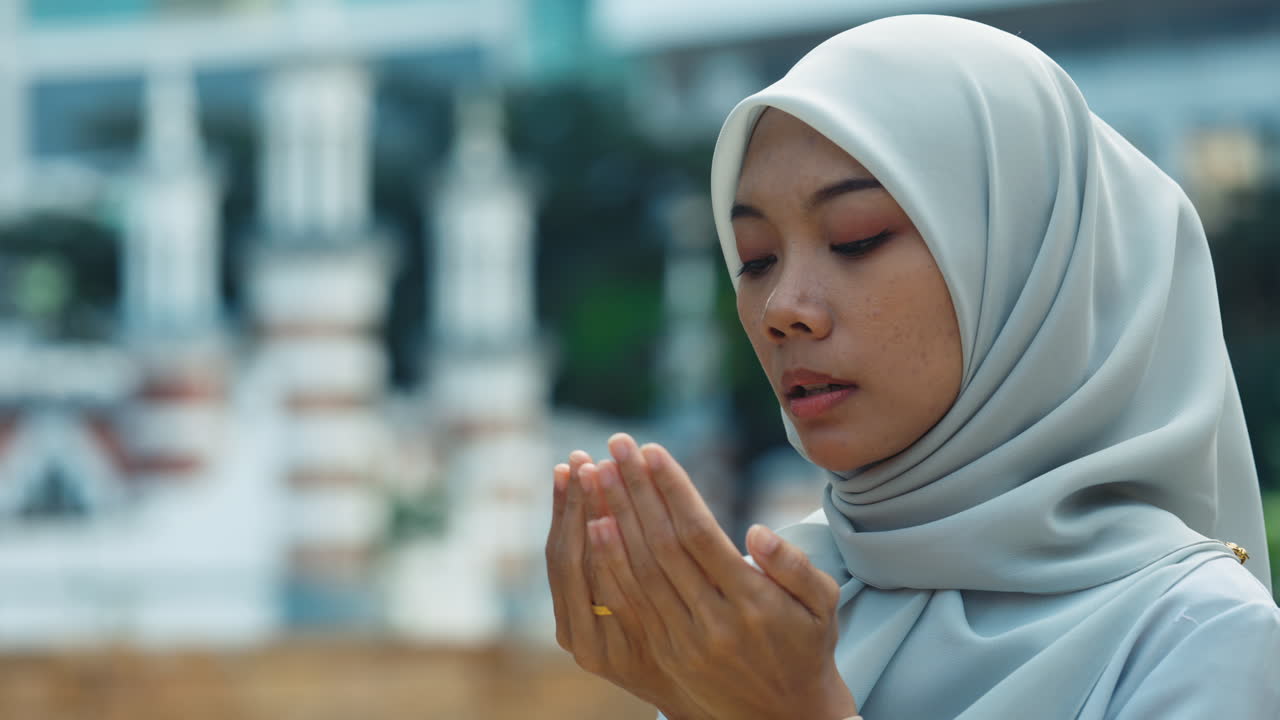 Muslim Woman Praying Outdoors in Hijab