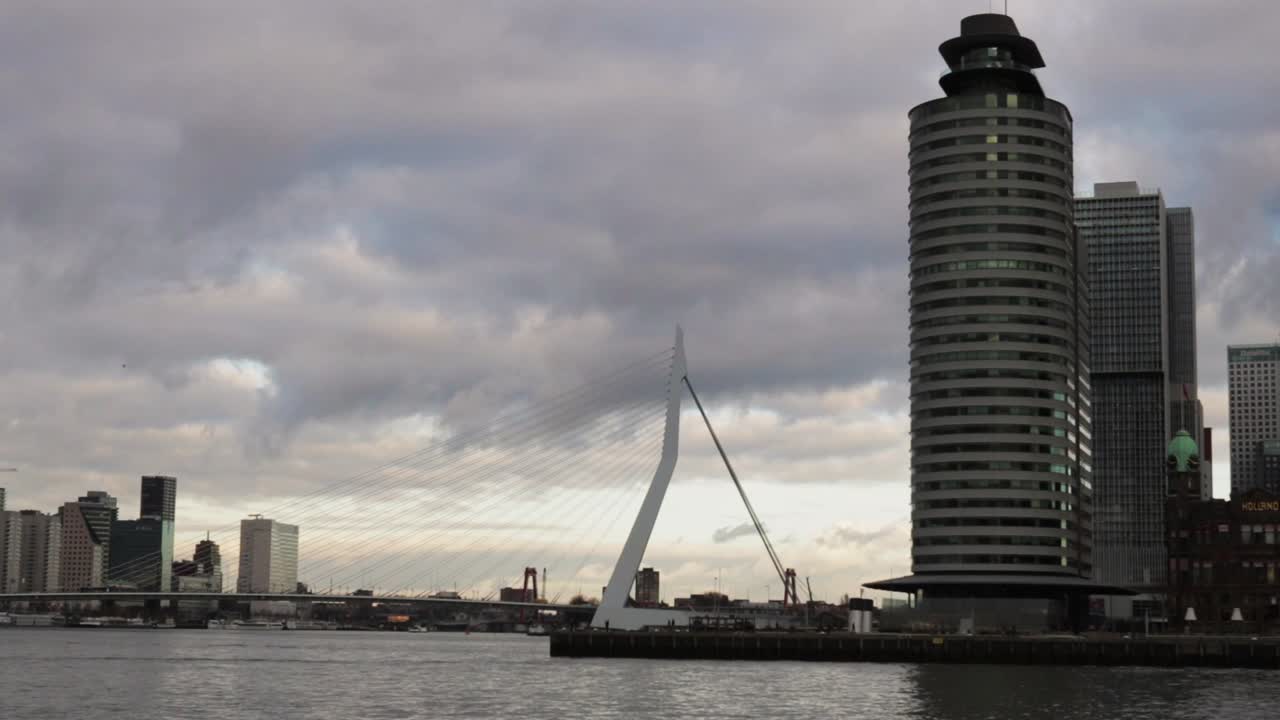 On a Moody, Cloudy Day in the Dutch City of Rotterdam some Water Taxis cross the River!