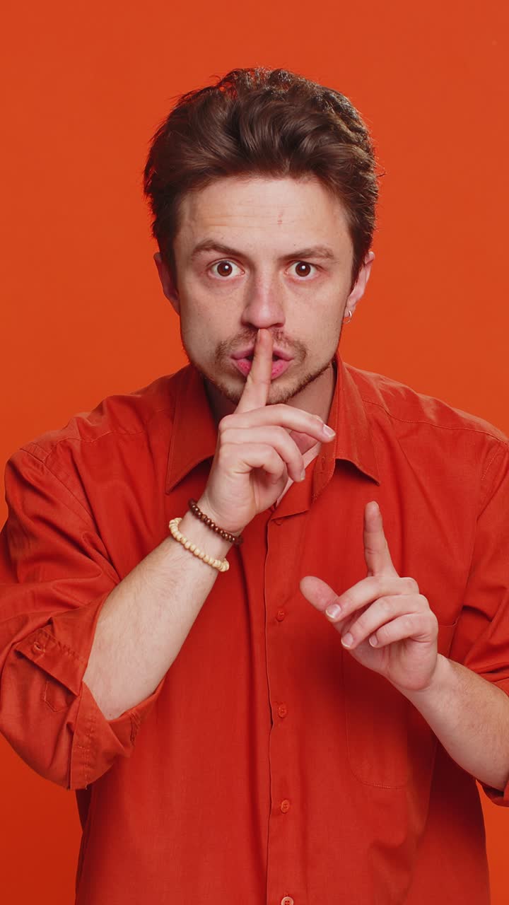 Giovane premere il dito alle labbra fare silenzio gesto segno non dice segreto smettila pettegolezzi privacy