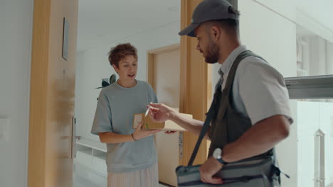 delivery man bringing parcels to woman at home