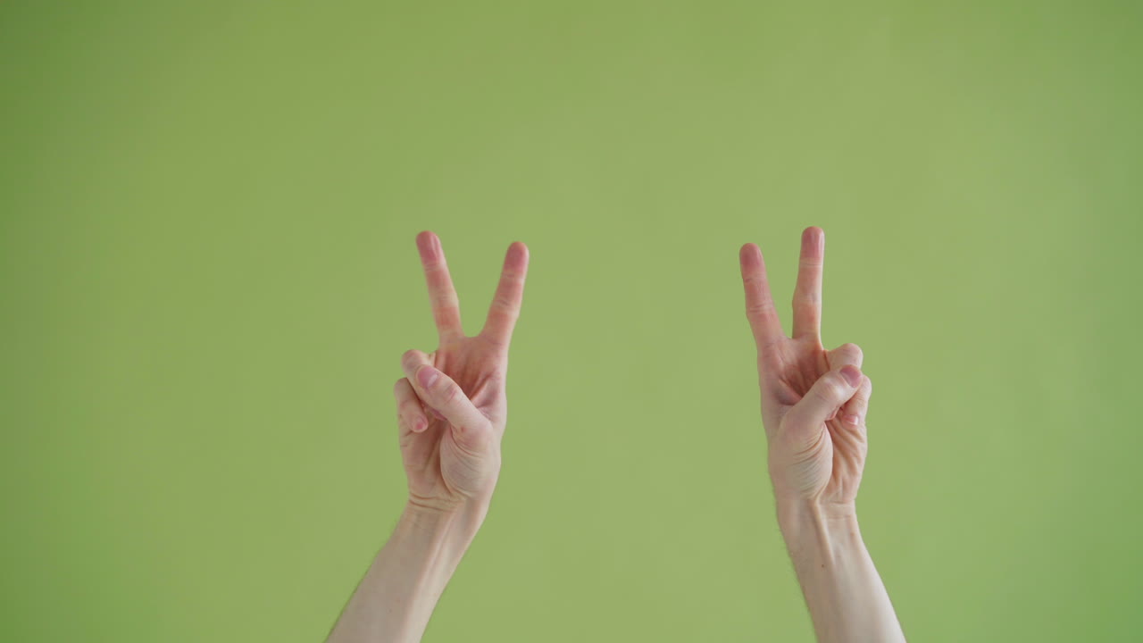 Two Hands Making Ok Sign on Green Background