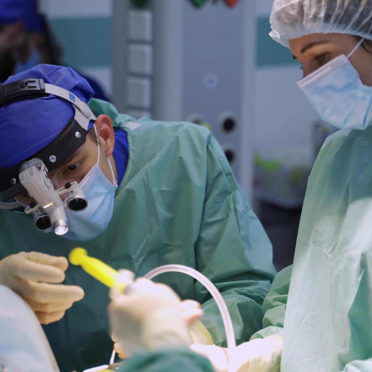 Surgeon in device glasses and mask slowly moves the instrument. Male neurosurgeon conducts precise spinal operation