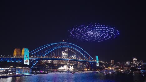 spiral - drone light display in front of sydney harbour bridge during vivid light festival 2023