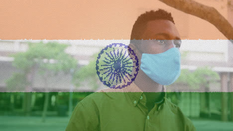 composition of man wearing face mask over indian flag
