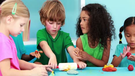 little children using modelling clay