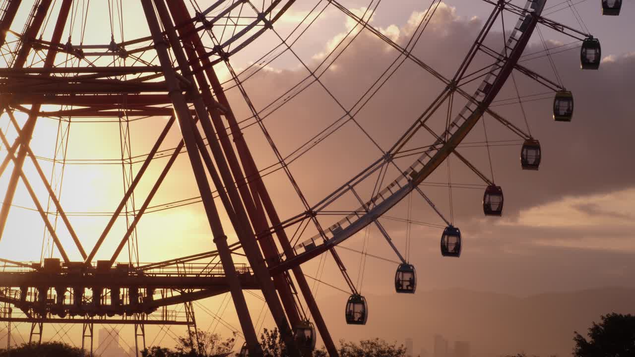Ferris wheel spinning against picturesque sunset