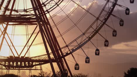 ferris wheel spinning against picturesque sunset