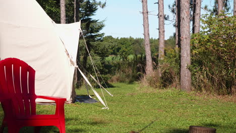 a green lawn is lying in front of a camping tent