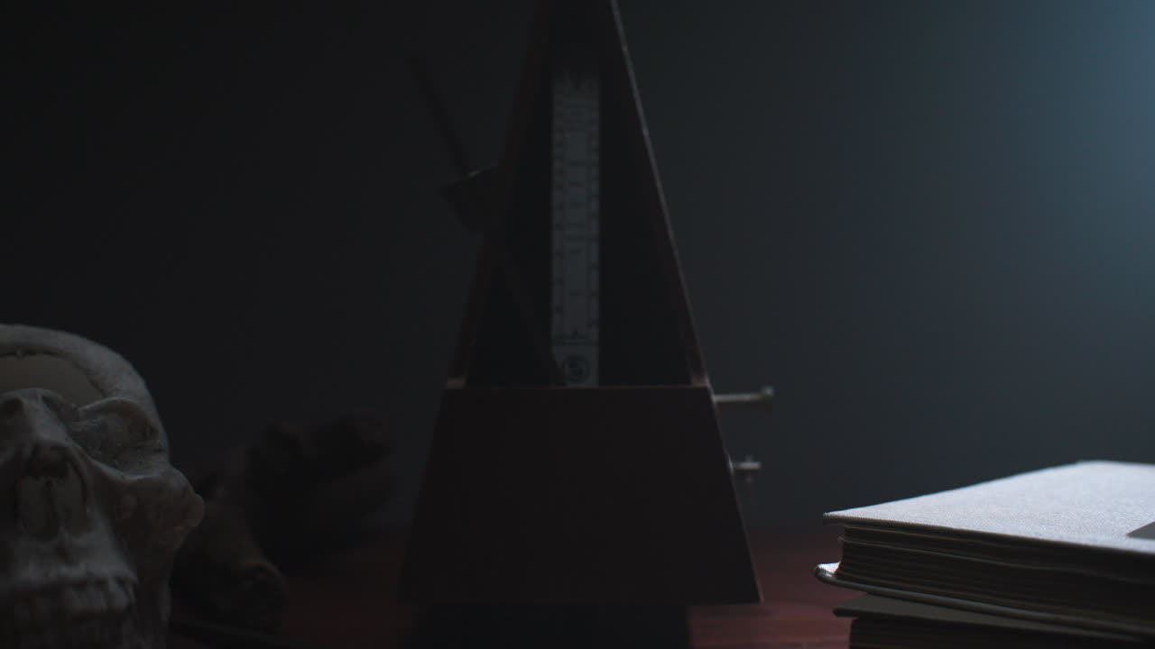 Metronome set the rythm in the dark, old room