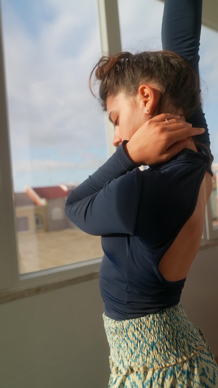 Woman dancing by the window