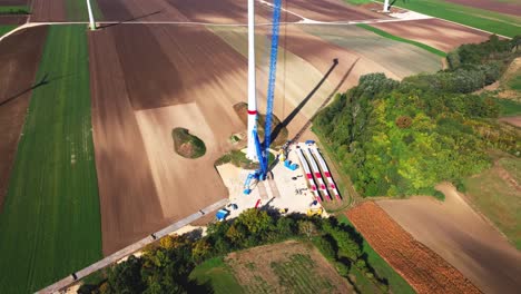 wind farm under construction - installation of towers and components of the turbine - aerial shot