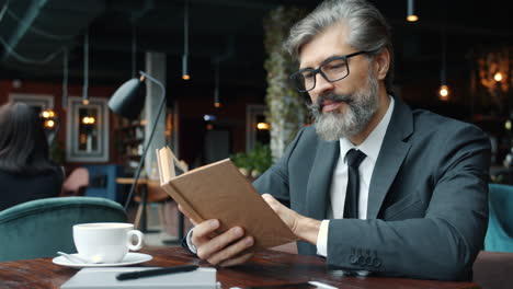 businessman reading in a cafe