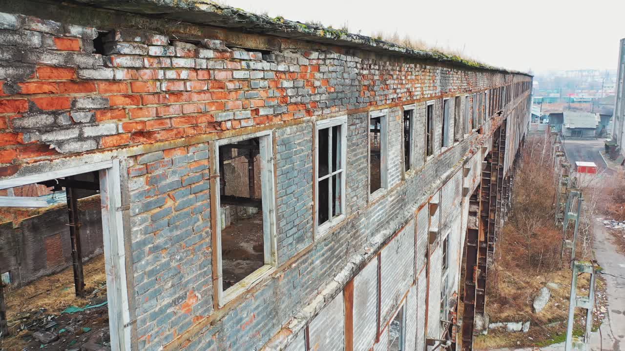 Aerial view of an old factory ruin and broken windows. Old industrial building for demolition.