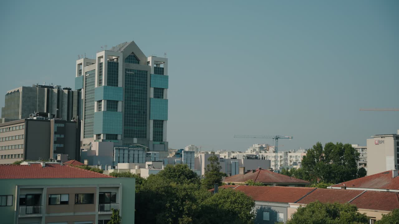 contemporary glass skyscraper in Porto Portugal with residential rooftops and city skyline