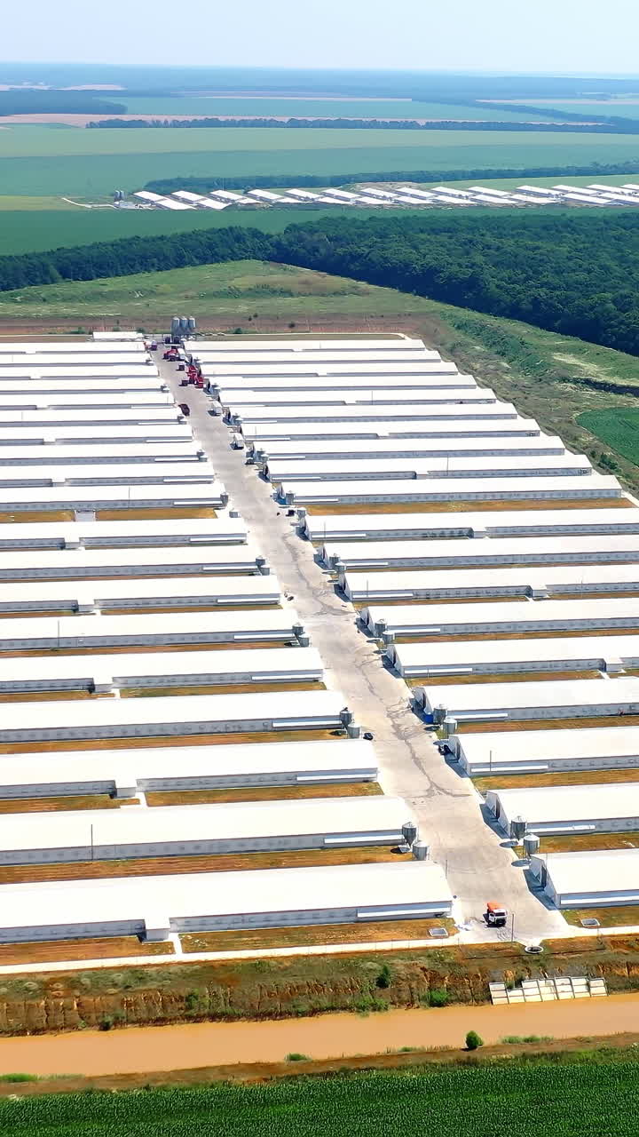 Modern agriculture plant fields farm buildings. Agricultural farming buildings aerial view. Vertical video