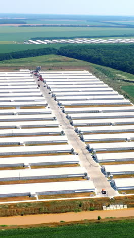 modern agriculture plant fields farm buildings. agricultural farming buildings aerial view. vertical video