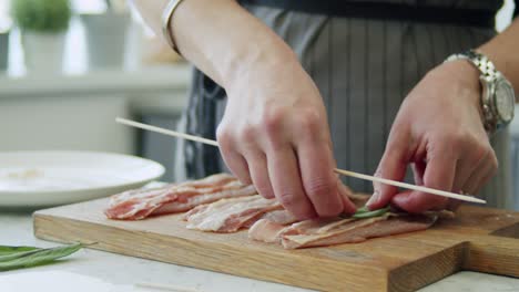 woman making saltimbocca consisting of veal with prosciutto and sage