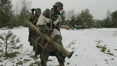 german soldiers with grenade launcher in a snowy forest