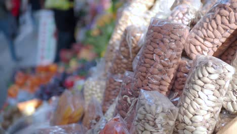 almonds and pistachios in bags at a market