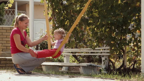 mother and daughter swinging