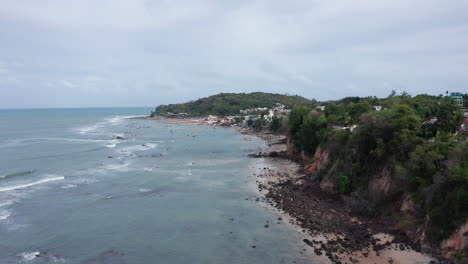AERIAL---Cliffs-on-rocky-Pipa-beach,-Rio-Grande-do-Norte,-Brazil,-forward