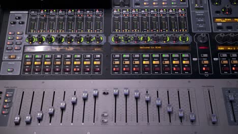 a colorful sound music mixer adjusting volume faders rapidly and flashing blinking lights