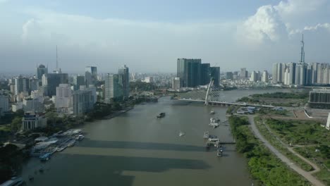 saigon river waterfront with long afternoon shadows from the ho chi minh city skyline, a symbol of modern vietnam