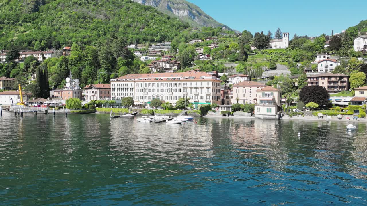 Drone view of Lake Como’s shoreline with elegant villas, lush gardens, and winding roads. A serene glimpse into Northern Italy’s luxurious lakeside lifestyle