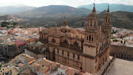 Spain-Jaen-Cathedral,-Catedral-de-Jaen,-flying-shoots-of-this-old-church-with-a-drone-at-4k-24fps-using-a-ND-filter-also-it-can-be-seen-the-old-town-of-Jaen