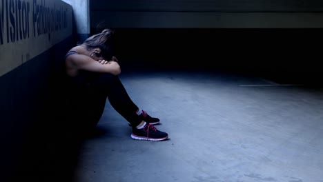 Woman-taking-break-in-underground-parking-area-4k