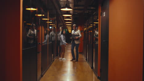 fired man in office hallway with box of books fired upset man in suit standing in office hallway holding box with books and personal stuff male employee leaving marketing company
