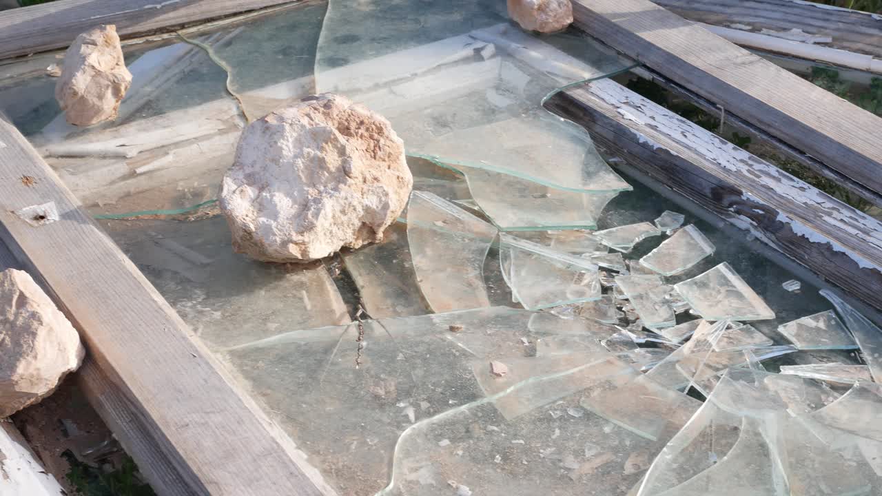 Broken windows and frames dumped alongside a country road